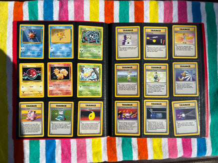 A album of approximately 940 Pokémon cards, including cards from Base Set 1  (1999) complete set of 1